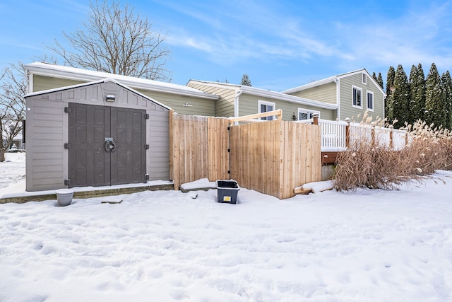 exterior space featuring an outdoor structure, fence, and a storage unit