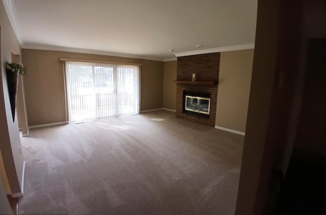 unfurnished living room with baseboards, a brick fireplace, carpet, and crown molding