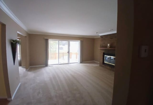 unfurnished living room featuring a brick fireplace, crown molding, and baseboards