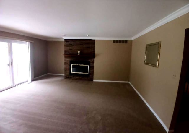 unfurnished living room with baseboards, visible vents, ornamental molding, carpet floors, and a brick fireplace