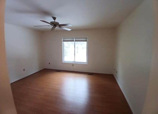 spare room featuring a ceiling fan and light wood finished floors