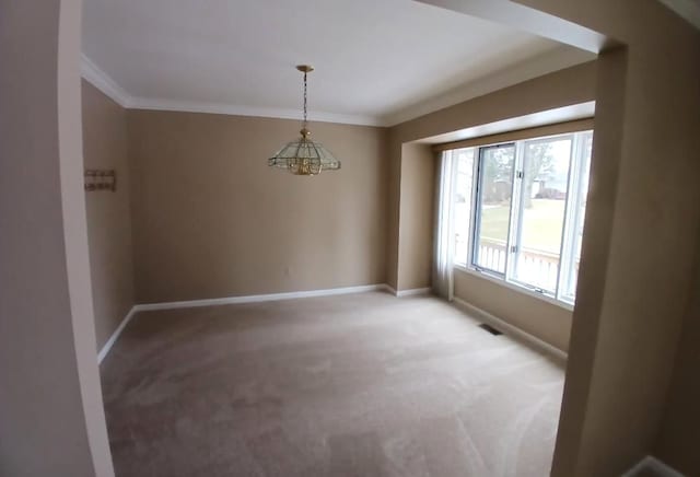 spare room featuring light carpet, visible vents, baseboards, and crown molding