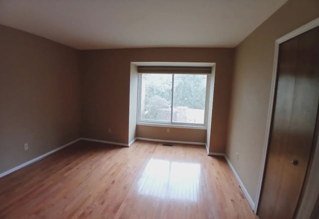 interior space with baseboards and light wood-style floors