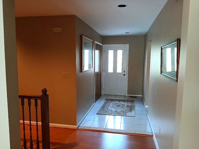 entryway featuring tile patterned flooring and baseboards