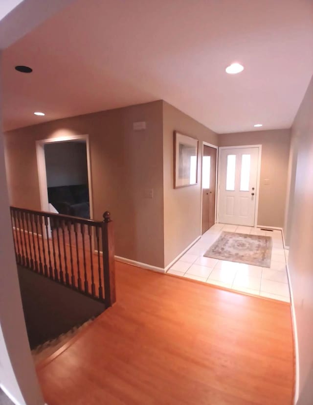 foyer featuring recessed lighting, baseboards, and wood finished floors