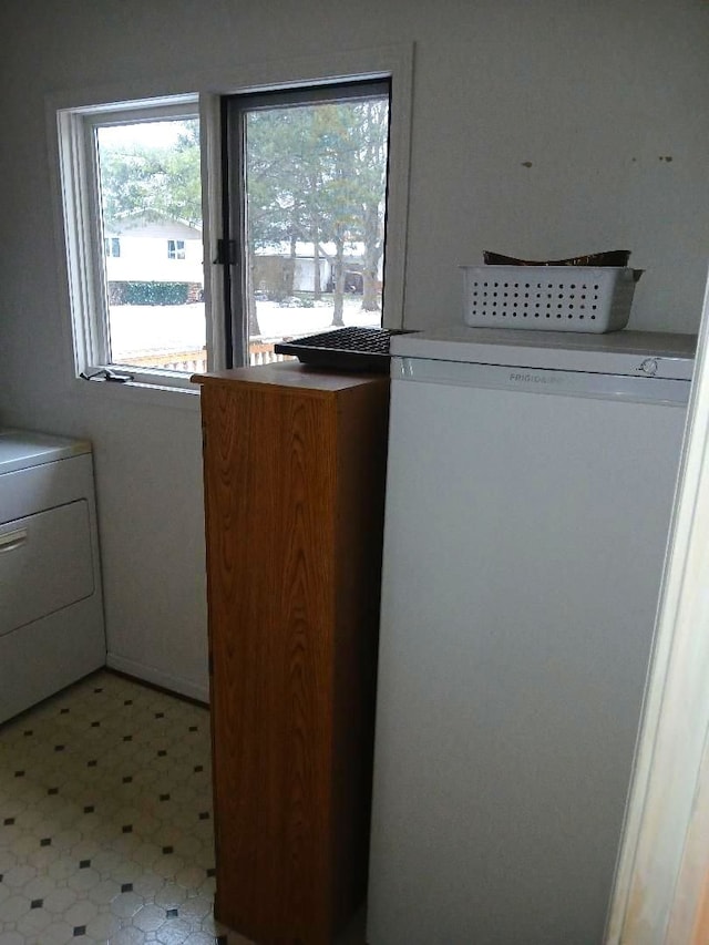 washroom with laundry area, washer / clothes dryer, and light floors