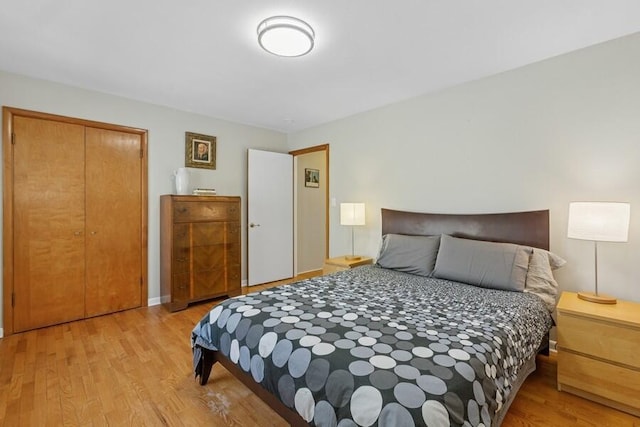 bedroom with a closet and light wood finished floors