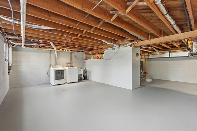 unfinished basement featuring separate washer and dryer and a sink