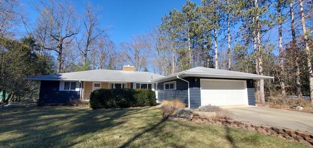 ranch-style home featuring driveway, a front lawn, a chimney, and an attached garage