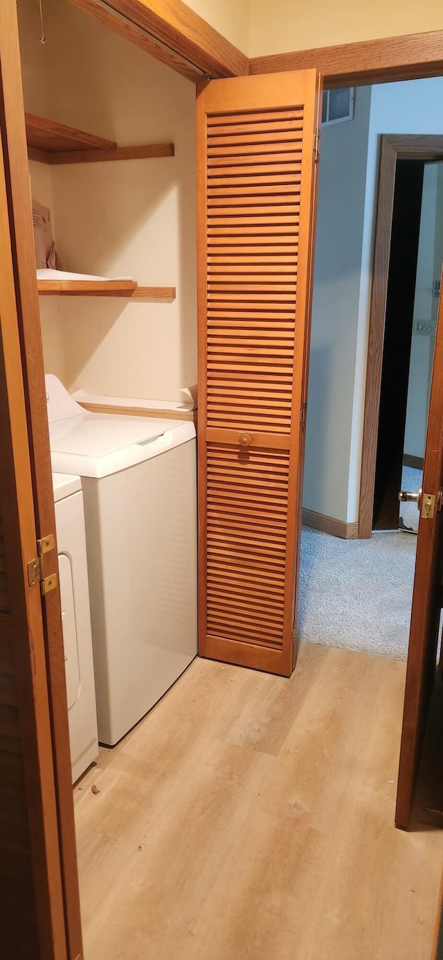 3075 Mineral Springs Trl, Mount Pleasant, MI 48858 - laundry room with independent washer and dryer and light wood-type flooring