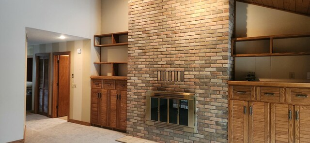 3075 Mineral Springs Trl, Mount Pleasant, MI 48858 - unfurnished living room with carpet flooring, a brick fireplace, vaulted ceiling, and baseboards