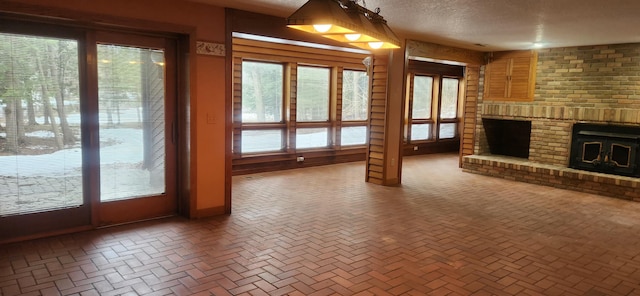3075 Mineral Springs Trl, Mount Pleasant, MI 48858 - unfurnished living room featuring a textured ceiling and a fireplace