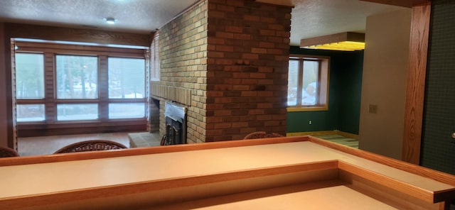3075 Mineral Springs Trl, Mount Pleasant, MI 48858 - unfurnished living room with a textured ceiling and a brick fireplace