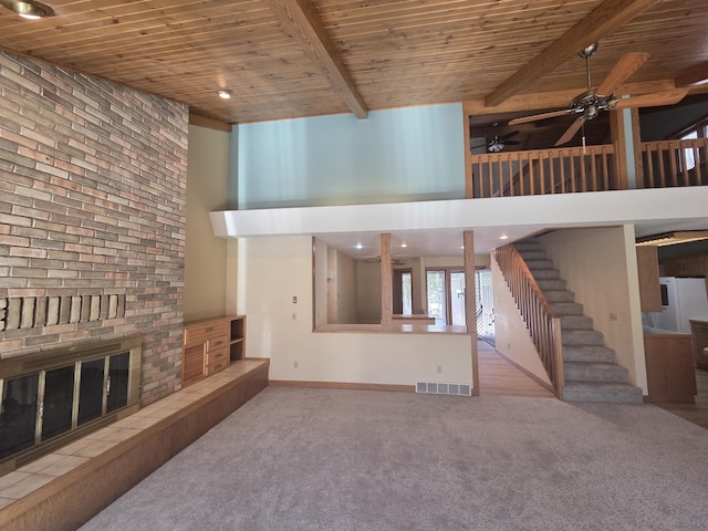 3075 Mineral Springs Trl, Mount Pleasant, MI 48858 - unfurnished living room with wood ceiling, a ceiling fan, carpet, a fireplace, and beamed ceiling