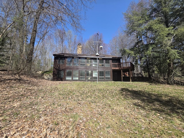 3075 Mineral Springs Trl, Mount Pleasant, MI 48858 - rear view of house featuring a chimney and a deck