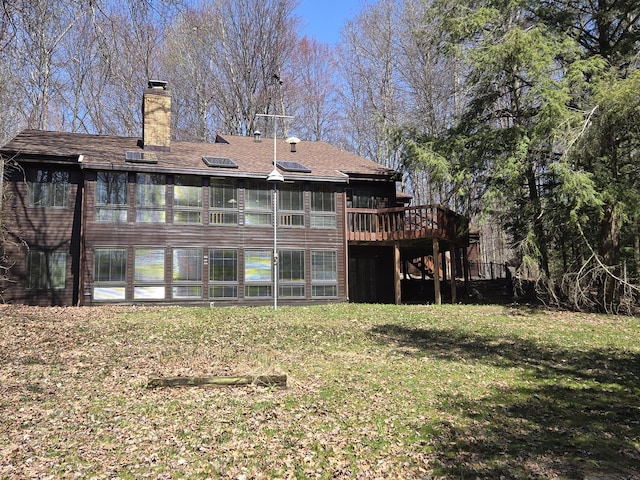 3075 Mineral Springs Trl, Mount Pleasant, MI 48858 - rear view of house with a deck, a yard, and a chimney