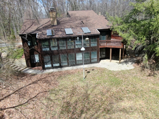 3075 Mineral Springs Trl, Mount Pleasant, MI 48858 - back of house featuring a chimney, a wooden deck, and roof with shingles
