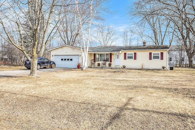 single story home with driveway, a front lawn, and a garage