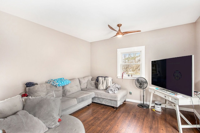 living area with a ceiling fan, baseboards, and hardwood / wood-style flooring