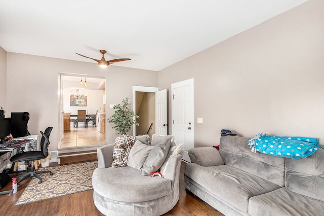 living area featuring a ceiling fan and wood finished floors