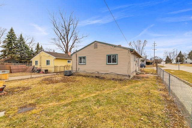 rear view of house featuring a fenced backyard and central AC unit