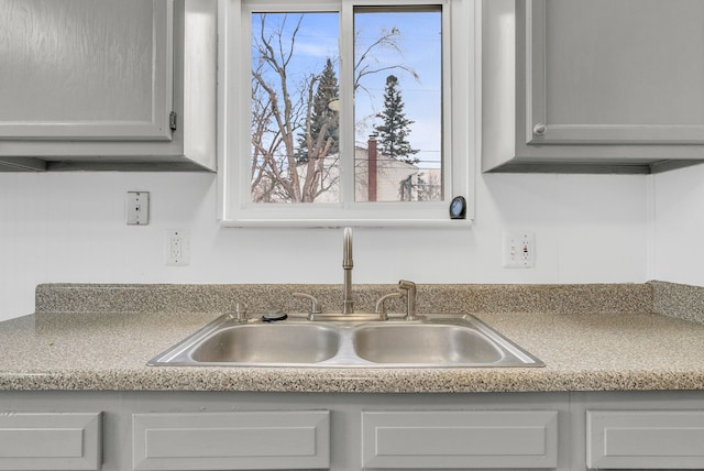 interior details featuring light countertops and a sink