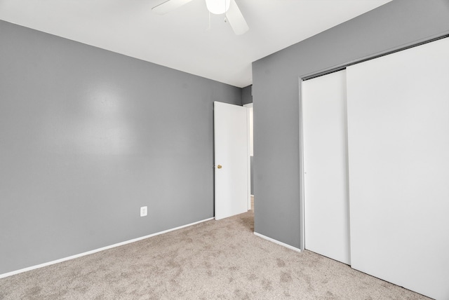 unfurnished bedroom featuring carpet floors, a ceiling fan, and a closet