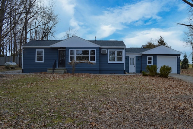 ranch-style house with an attached garage and a front yard