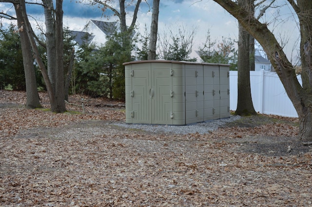 view of shed with fence