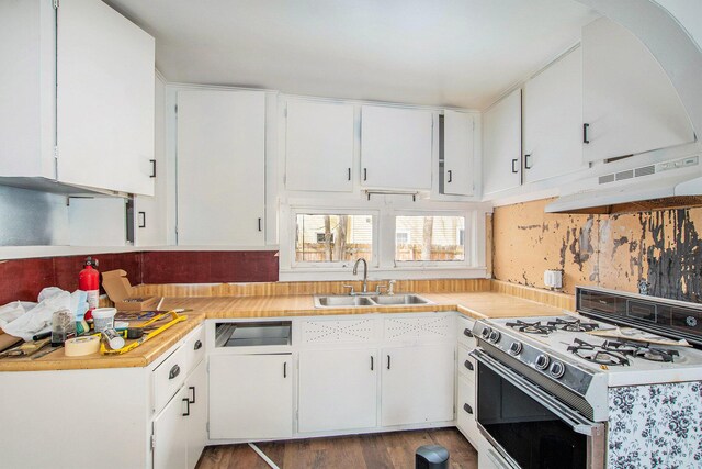 kitchen with under cabinet range hood, a sink, white cabinets, light countertops, and white gas range oven