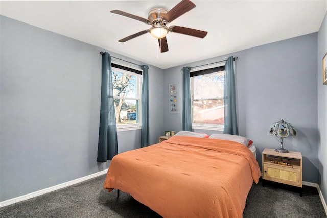 bedroom featuring carpet floors, multiple windows, and baseboards