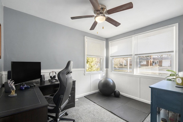 office with carpet floors, wainscoting, and ceiling fan