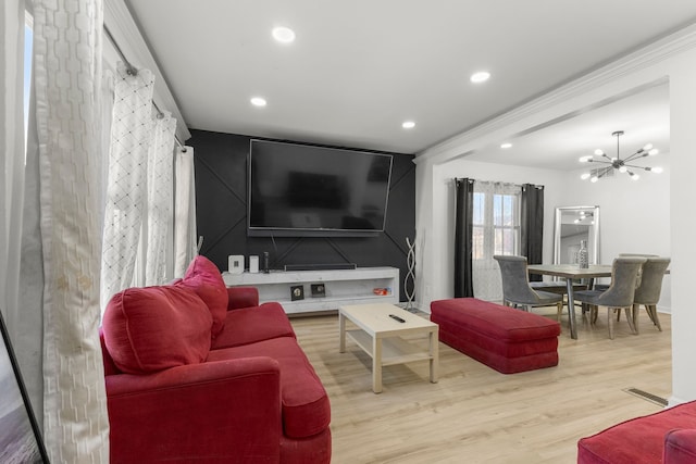 living area featuring recessed lighting, wood finished floors, visible vents, and a chandelier