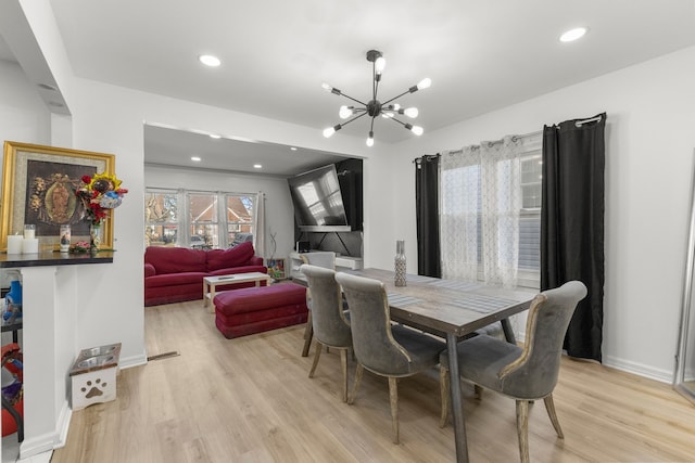 dining room featuring recessed lighting, baseboards, light wood-style floors, and an inviting chandelier