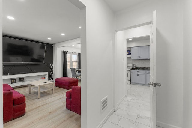 hallway featuring recessed lighting, visible vents, marble finish floor, and baseboards