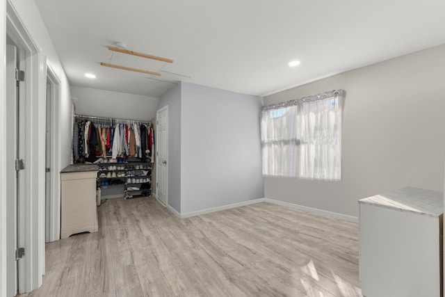 bedroom featuring recessed lighting, light wood-type flooring, baseboards, and a closet