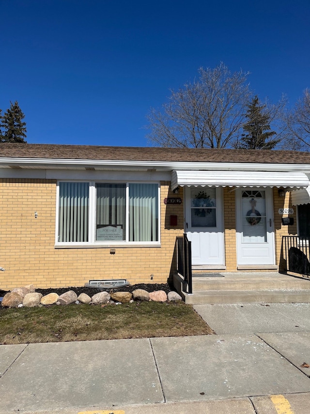 view of front of house featuring brick siding