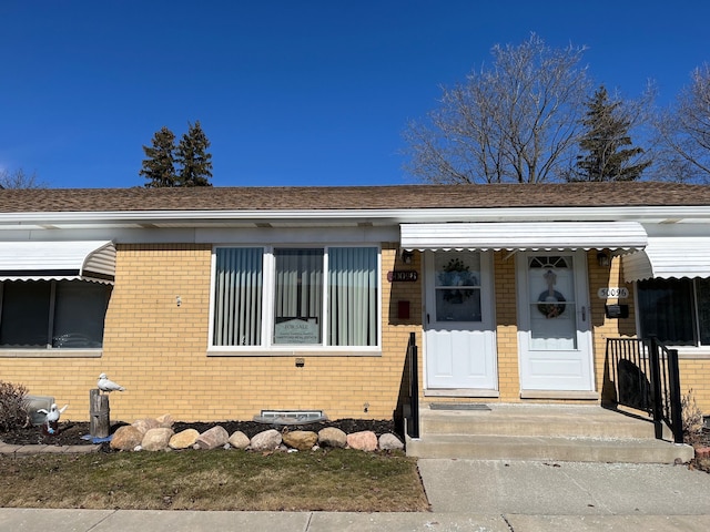 view of front of house with brick siding