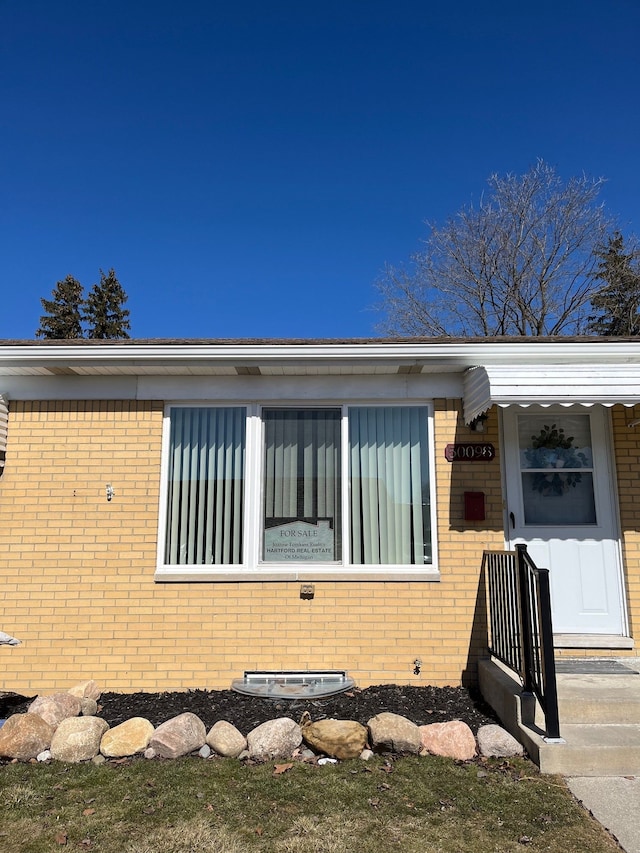 view of side of home featuring brick siding