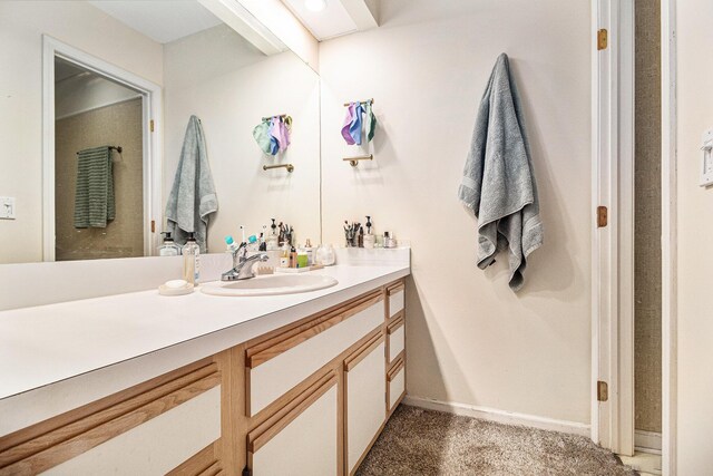 bathroom with baseboards and vanity