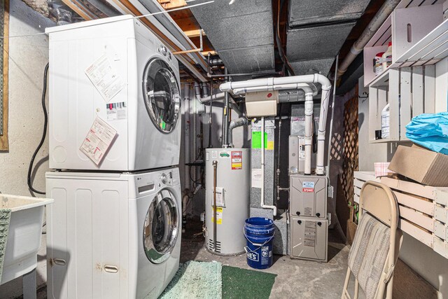 laundry area featuring laundry area, gas water heater, and stacked washer and clothes dryer