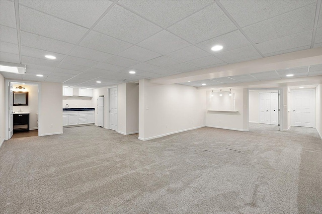 finished basement with recessed lighting, light colored carpet, and baseboards