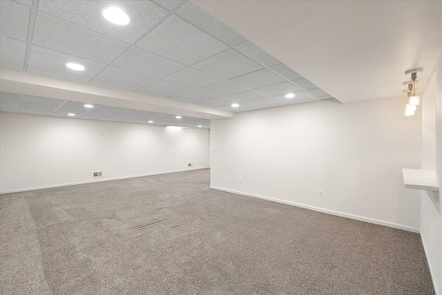 finished basement with carpet, visible vents, baseboards, and recessed lighting