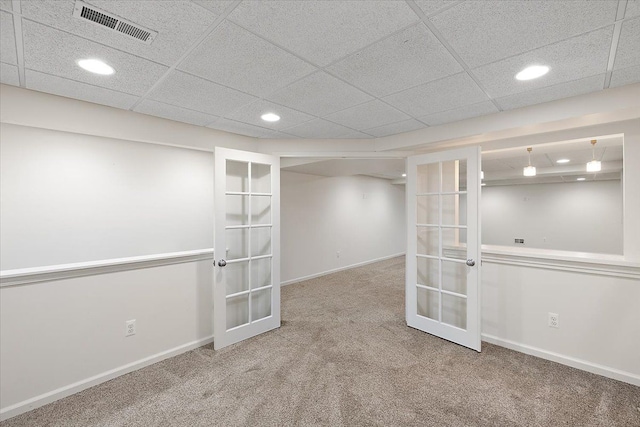 finished basement featuring french doors, carpet, visible vents, and baseboards