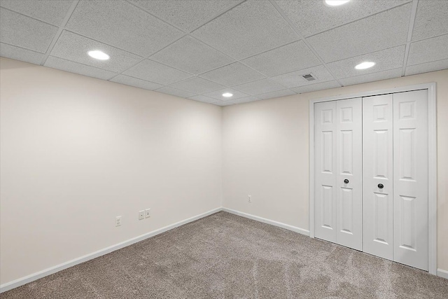 basement featuring carpet floors, recessed lighting, a paneled ceiling, visible vents, and baseboards