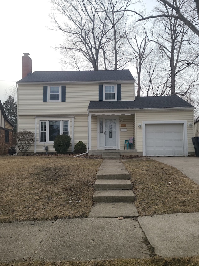 view of front of house with a garage, a chimney, and concrete driveway