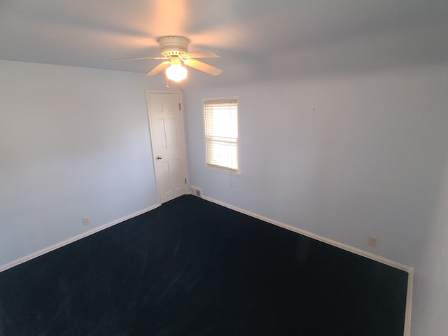 unfurnished room with ceiling fan, visible vents, and baseboards