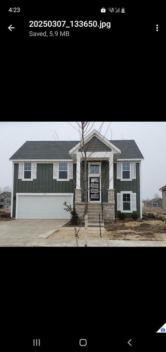 view of front facade with board and batten siding, cooling unit, and stairway