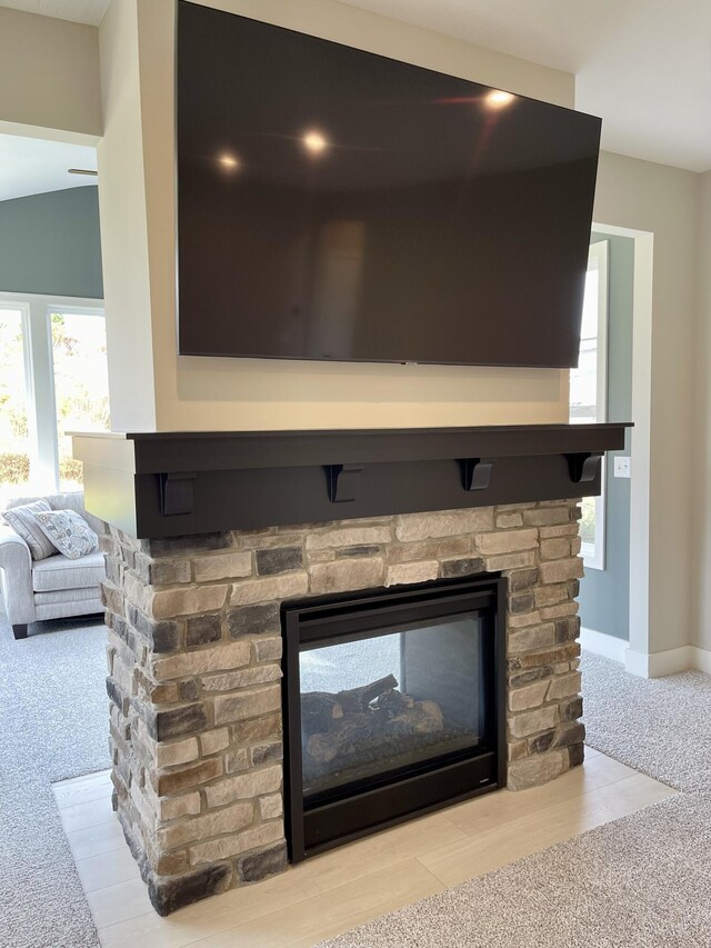 details featuring carpet flooring, a fireplace, and baseboards