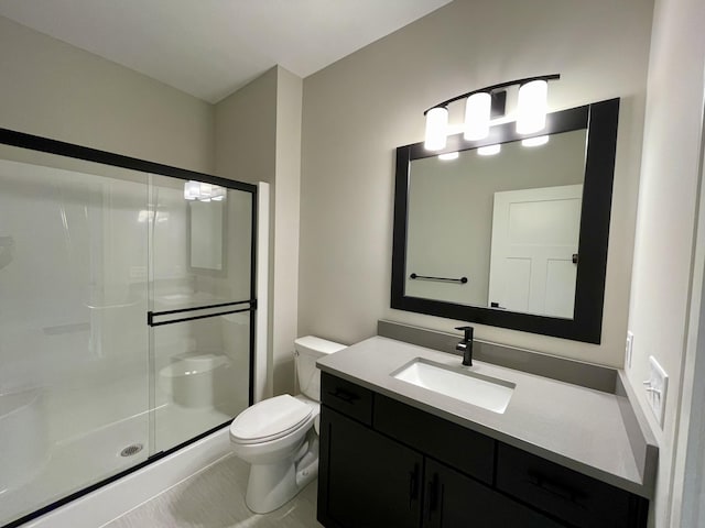 bathroom featuring a shower stall, toilet, and vanity